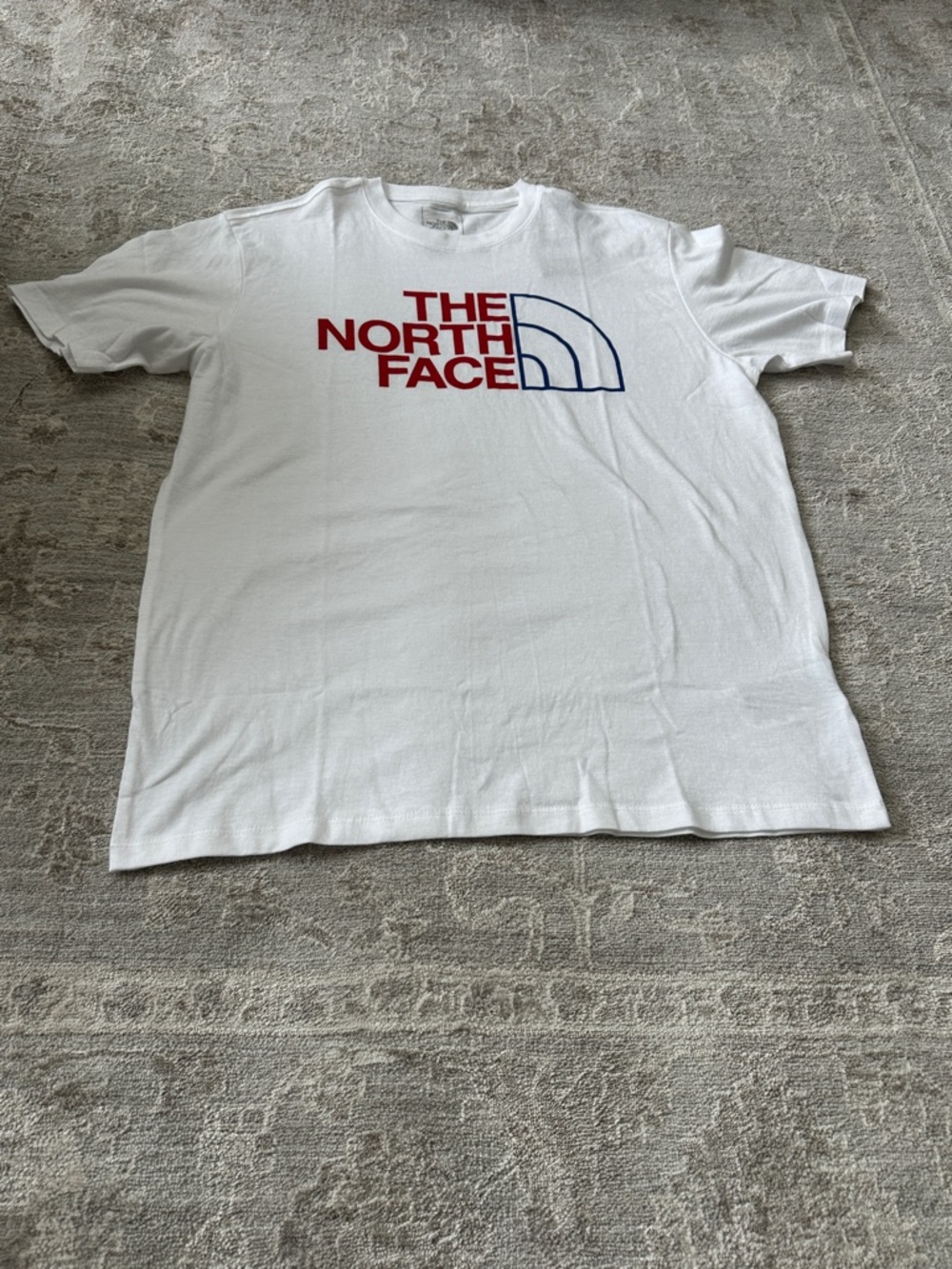 The North Face White Men’s Medium Short-Sleeve Tee with RedBlue half dome.